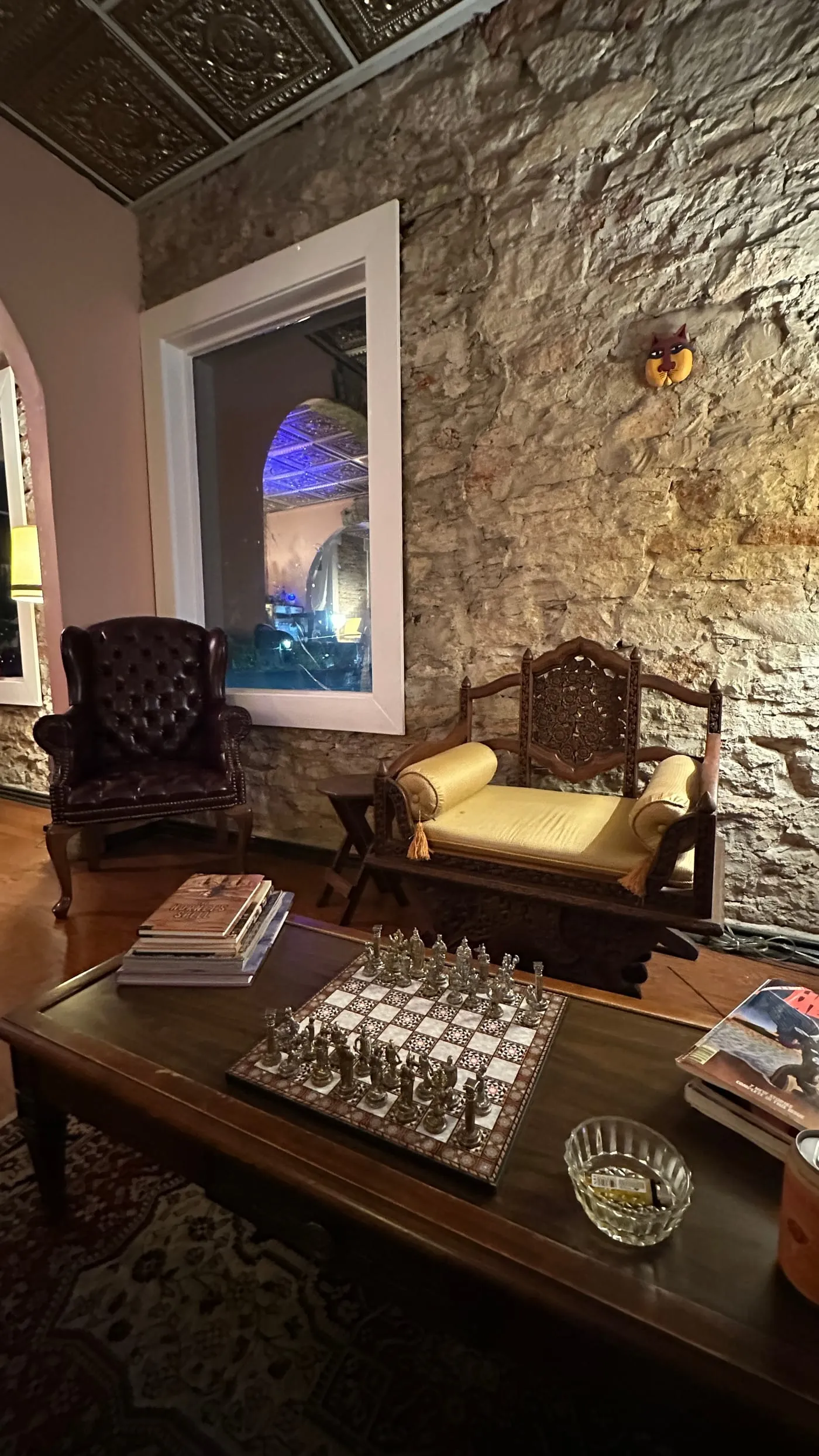 Leather lounge seating against exposed stone inside the dispensary